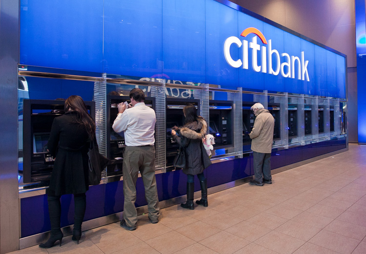 People use the ATM machines at a Citibank branch in New York City