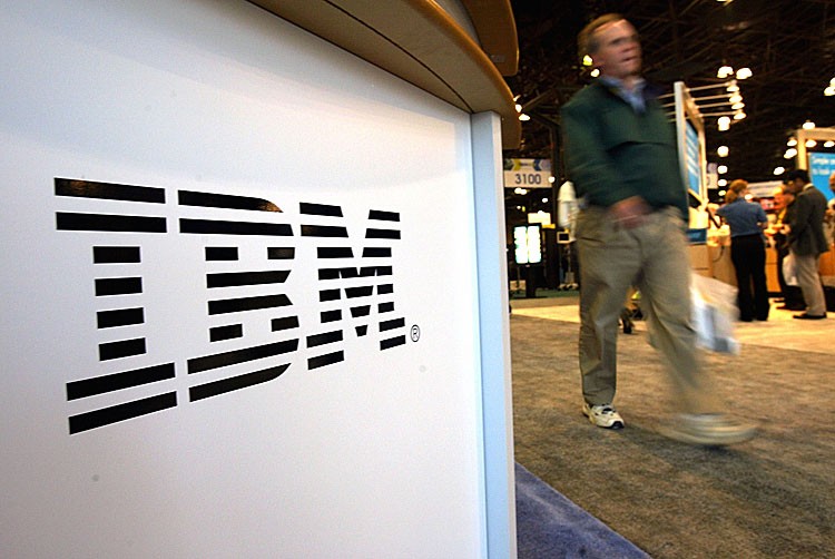 IBM NEW YORK: A person walks past an IBM sign in New York outside a technology show in 2004. (SPENCER PLATT/GETTY IMAGES)