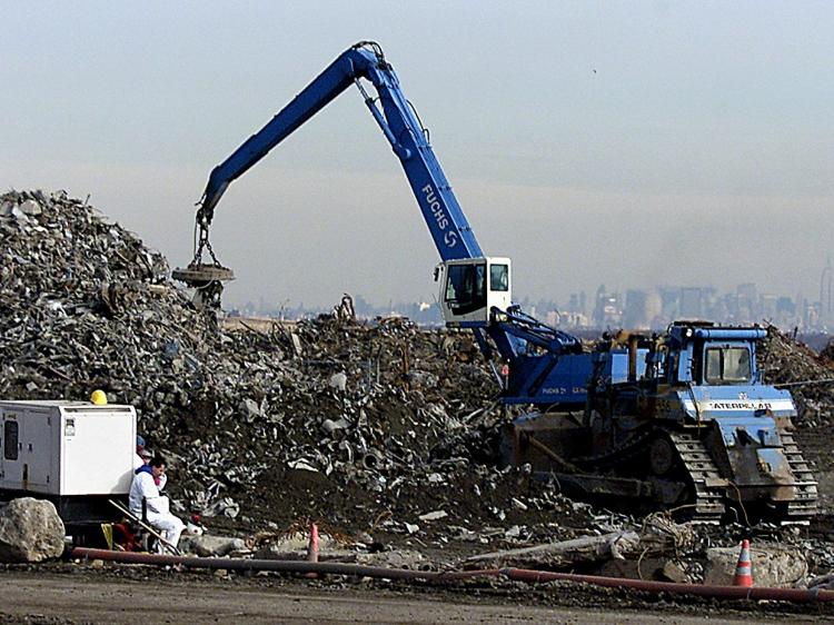 WTC DEBRIS: Cranes move World Trade Center debris at the Fresh Kills Landfill Jan. 14, 2002. As of Jan. 3, 2002, crews had removed 951,272 tons of debris from the site and placed it at Fresh Kills. (Don Emmert/AFP/Getty Images)