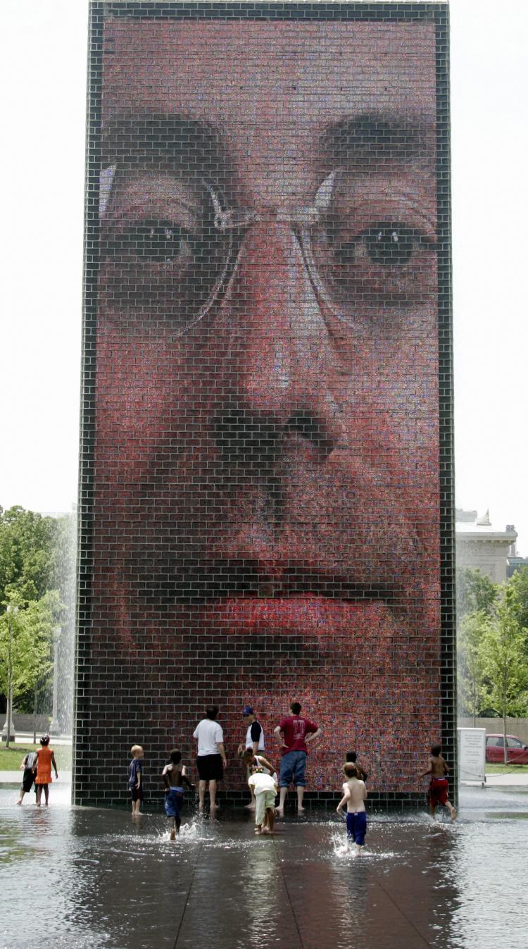 CROWN FOUNTAIN: The Spanish artist Plensa designed Crown Fountain at Millennium Park in Chicago, Ill. It consists of a shallow reflecting pool between two 50-foot glass towers facing each other and projecting images of Chicago citizens. (Jeff Haynes/Getty Images)