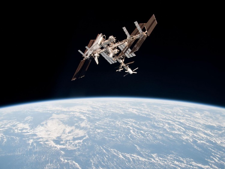 This image of the International Space Station and the docked space shuttle Endeavour, flying at an altitude of approximately 220 miles, was taken by Expedition 27 crew member Paolo Nespoli from the Soyuz TMA-20 following its undocking on May 23, 2011 (USA Time). (NASA)