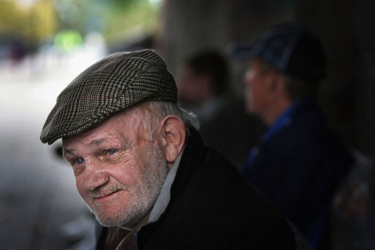 A homeless man sits under a bridge where he lives on the banks of the River Clyde, on Ocotober 5, 2005 in Glasgow, Scotland.