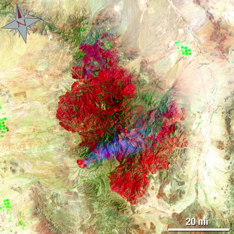 The Horseshoe 2 Fire in southeastern Arizona on June 15. This false-colored image uses a 7, 4, 2 band combination and shows the burn scar in red the fire ongoing in really bright red, vegetation is green, smoke is blue and bare ground is tan. (NASA/USGS, Mike Taylor)