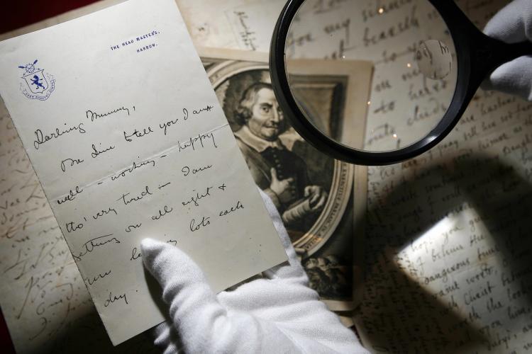 An employee of Christies Auction House inspects a handwritten letter by former British Prime Minister Winston Churchill.  On Wednesday, a collection of Churchill memorabilia including letters and photographs sold for $846,364 at the auction house. (Leon Neal/Getty Images )