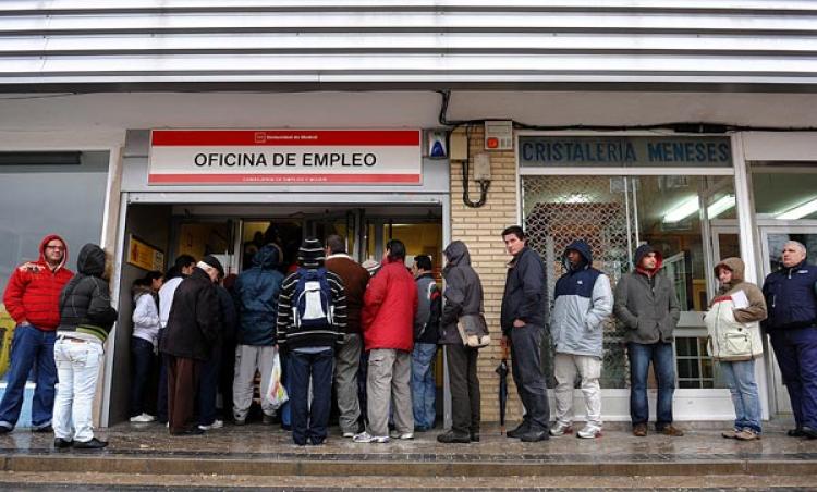 Unemployed wait in line at a government employment office on Feb. 5 in Madrid, Spain. Unemployment is higher in Spain than anywhere else in the EU, which is also affecting migrant workers from other parts of Europe. (JASPER JUINEN/GETTY IMAGES)