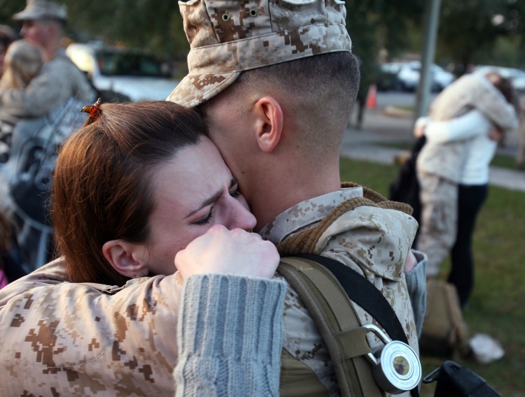 Corporal Adam Marano hugs his wife Melissa Marano as the Marines in the 3rd Battalion prepare to deploy to Afghanistan in North Carolina this file photo from 2009. Repeated deployments to warzones are putting a tremendous pressure on today's troops. (Logan Mock-Bunting/Getty Images)