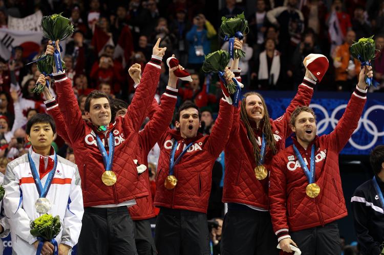 (L-R) Guillaume Bastille, Charles Hamelin, Francois Hamelin, Olivier Jean, and Francois-Louis Tremblay of Canada stand atop the podium after the men's 5000 m relay short track speed skating. (Matthew Stockman/Getty Images)