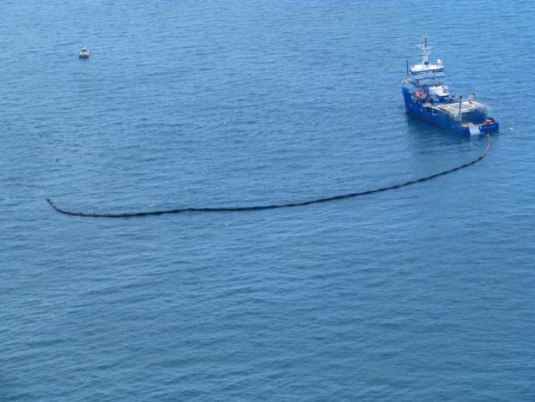 Response boats work to clean up oil where the Deepwater Horizon oilrig sank April 22, 2010 in the Gulf of Mexico off the coast of Louisiana. (U.S. Coast Guard via Getty Images)