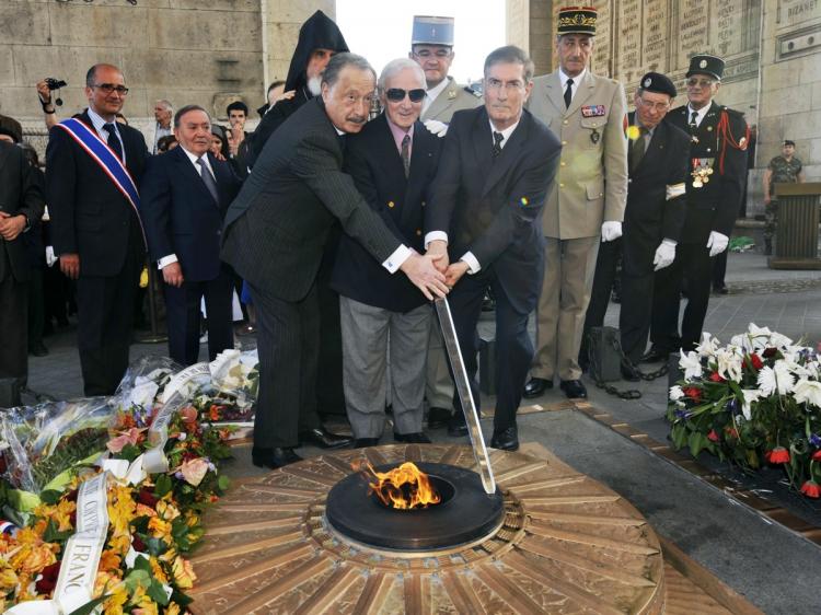 Armenian ambassador to Switzerland and Armenia's permanent delegate to the United Nations office in Geneva, French-Armenian singer Charles Aznavour (C) and Armenian ambassador in France Viguen Tchitechian (L) light the flame at the tomb of the unknown soldier beneath the Arc de Triomphe on April 24, during a ceremony to commemorate the 95th anniversary of Ottoman-era mass killings of Armenians in Constantinople 1915. Turkey fiercely denies the incident and there are concerns for future peace in the region. (Mehdi Fedouach/AFP/Getty Images)