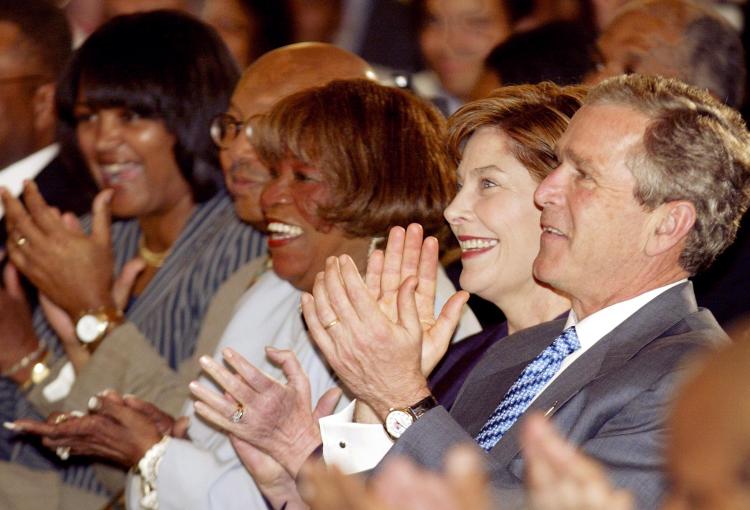 US President George W. Bush (R), First Lady Laura Bush(2nd-R), and Gospel singer Albertina Walker(C) attend the Celebration of African-American Music, History, and Culture at the White House in Washington, DC 31 May, 2002. (Luke Frazza/AFP/Getty Images)