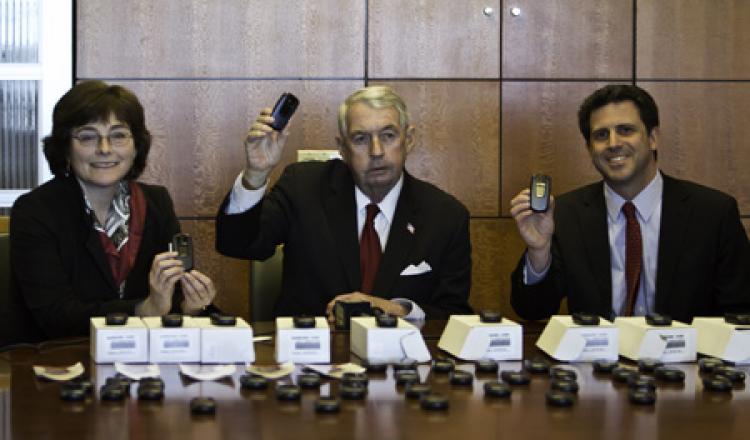 PHONES FOR VICTIMS: (L to R) Wanda Lucibello, District Attorney Charles Hynes, and David Samberg. (Phoebe Zheng/The Epoch Times)