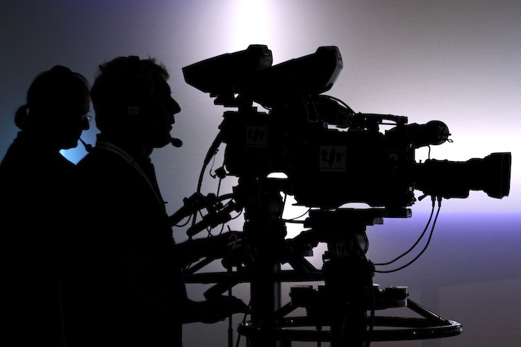 Television cameramen film in a broadcast studio in this file photo. A recent Gallup poll found that more than half of Americans surveyed do not trust the media. (Fabrice Coffrini/Getty Images)