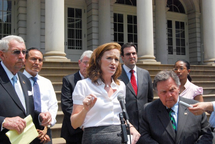 District Attorneys Charles Hynes from Kings County (L), Kathleen Rice (C) from Nassau County, and Richard Brown from Queens County join district attorneys from all over New York to call for reforms on 'no fault' insurance laws on the steps of City Hall in (Catherine Yang/The Epoch Times)