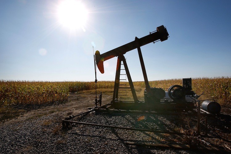 An oil well sits in the middle of a corn field in Illinois, a top ethanol-producing state, in this file photo. Consumer complaints of engine damage caused by the gasoline/ethanol blend E15 have prompted a bill calling for more independent testing.  (Scott Olson/Getty Images)