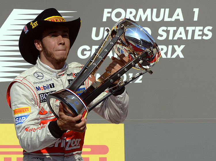 McLaren Mercedes driver Lewis Hamilton celebrates on the podium after winning the Formula One United States Grand Prix at the Circuit of the Americas on November 18. (Timothy A. Clary/AFP/Getty Images) 