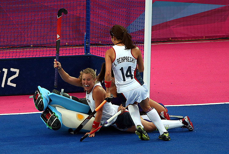 Shannon Taylor (down) of the United States celebrates scoring the first goal during the Women's Hockey Match between Argentina and the United States on day 4 of the London 2012 Olympic Games. (Daniel Berehulak/Getty Images)