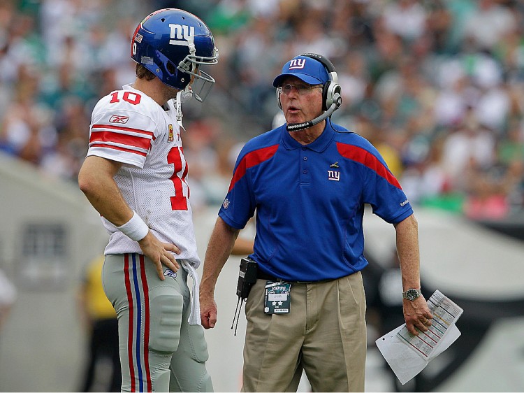 Eli Manning and Tom Coughlin discuss strategy in the final&8212and decisive&212quarter on Sunday. The Giants erased last year's collapse with a comeback win of their own. (Rob Carr/Getty Images)