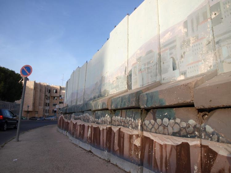 The Israeli government this week started dismantling a protective wall that was erected eight years ago to separate the Israeli settlement of Gilo from the West Bank. The guns and motor attacks that were common then, have been silent for years. (Tova Kokaso/The Epoch Times )