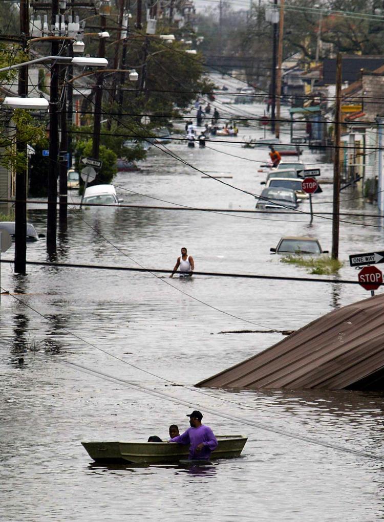 Residents wade through a flooded street in New Orleans, 29 August 2005, after hurricane Katrina made landfall. As Hurricane season approaches in the Atlantic, worries about the dangers of a hurricane forming over the catastrophic oil spill are growing. (James Nielsen/Getty Images)