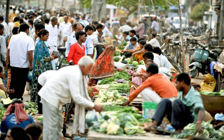 Indian residents purchases vegetables at a roadside vegetable market in Allahabad on April 1. India has started counting its teeming billion-plus population for a new census that will gather biometric data for the first time from across the vast and chaotic nation. (Diptendu Dutta/AFP/Getty Images)