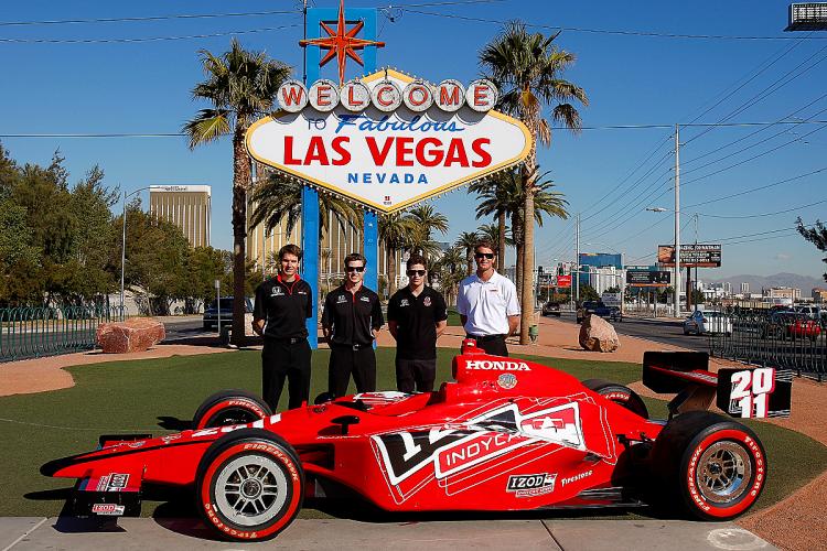 IndyCar drivers Will Power, Ryan Briscoe, Marco Andretti, and Ryan Hunter-Reay pose with a Dallara Honda on the Las Vegas Strip. (Courtesy IndyCar.com)