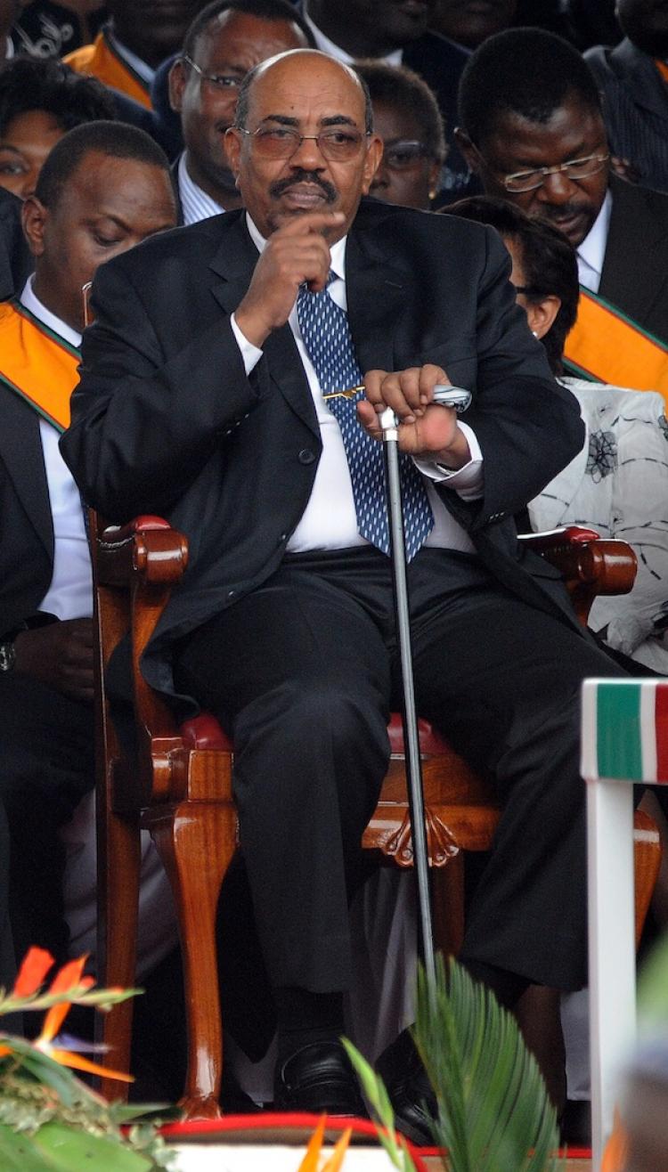 DISPUTED VISITOR: Sudanese President Omar Hassan al-Bashir gestures during the promulgation ceremony of Kenya's new constitution at Uhuru Park Aug. 27 in Nairobi. Kenya's prime minister Sunday, condemned his county's failure to arrest Bashir, who is wanted on charges of genocide by the International Criminal Court. (Simon Maina/Getty Images)