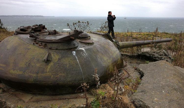 Russian President Dmitry Medvedev walks near a Soviet-era fortification during his visit to Kunashir one of the Kuril Islands on Nov. 1. Medvedev stoked Japan's ire on Monday with a visit to the Kuril Islands, a remote territory at the heart of a decades-long dispute with Tokyo.  (Mikhail Klimentyev/AFP/Getty Images)