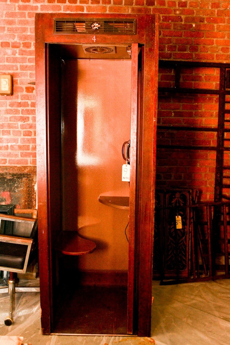 An old phone booth on display at the Landmark and Preservation Council's warehouse in Brooklyn. (Tara MacIsaac/The Epoch Times)