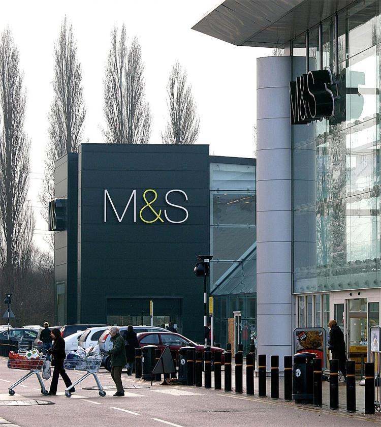 Shoppers are pictured outside a Sainsbury's supermarket (R) and British clothier Marks and Spencer faces a lawsuit over claims that it used online searches for competitors to direct business to itself. (Max Nash/AFP/Getty Images)