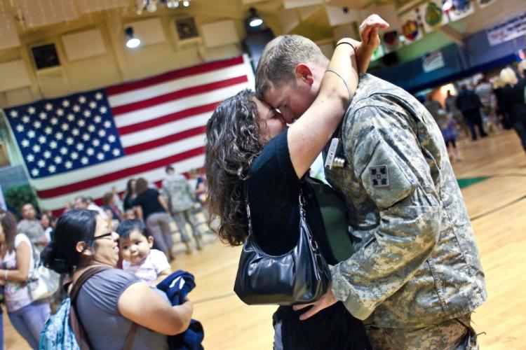 U.S. Army Spc. Tim McCulloch embraces his girlfriend Deanna Meder after arriving home from Iraq on Aug. 23 to Fort Carson, Colo. McCullouch, from the 4th Infantry, is among the many U.S. soldiers returning home from Iraq, as Operation Iraqi Freedom draws to a close. (John Moore/Getty Images)