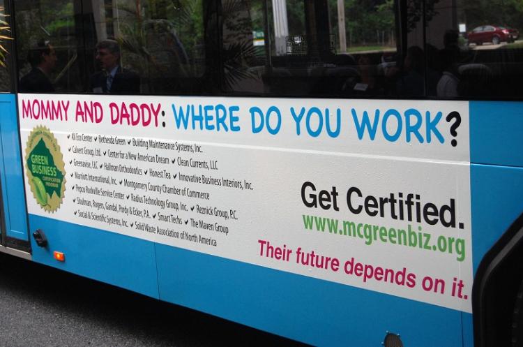 The side of a Ride On bus in Maryland displays an ad for the first 20 green-certified businesses and organizations.  (The Epoch Times)