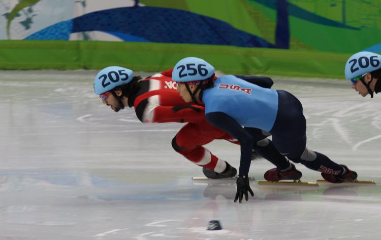 Apolo Ohno (256) closes in on the front position before a slip caused him to fall from second to last position. He came back in the last moments of the race to claim bronze, making him the most-winning winter Olympian in U.S. history.  (Matthew Little/The Epoch Times)