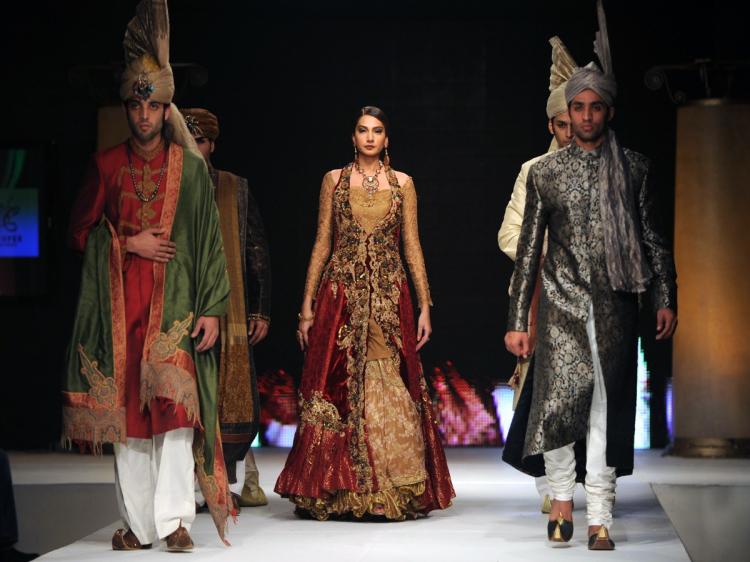 ISLAMABAD FASHIONS: Models demonstrate outfits by Pakistani designers Sanam Agha, Huma Adnan, and Nilofer Shahid. The range of outfits and colors demonstrate the diversity of design features, combining both traditional Pakistani elements and modern featur ( Aamir Qureshi/AFP/Getty Images)