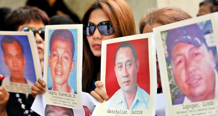 Relatives of journalists killed in the Philippines display portraits of their loved ones during a rally in front of the Department of Justice office in Manila on April 21.  (Ted Aljibe/Getty Images)