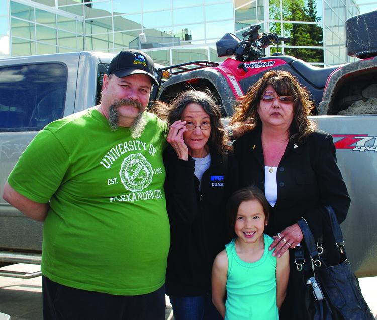 Bob Boudreau and family members wait at the Edmonton Expo centre, a temporary evacuation shelter, to hear when they can return to their home in Red Earth, Alberta. Red Earth, about 165 km north of Slave Lake was one of the towns evacuated when wildfires swept across Northern Alberta. (George Qu/The Epoch Times)