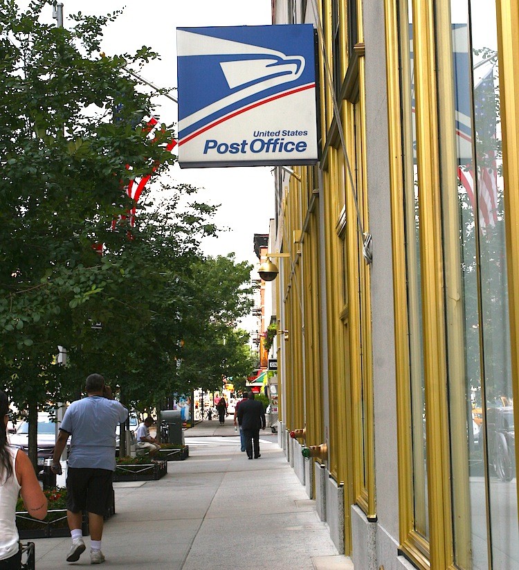 The U.S. Post Office in Midtown Manhattan. The Postal Service plans on cutting more work hours, closing unused branches, and restructuring its organization.   (Jaya Gibson/The Epoch Times)