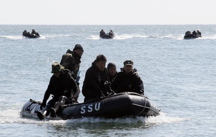 South Korean Marines and Navy's Ship Salvage Unit (SSU) members search for possible survivors and bodies from sunken naval ship on March 28 in Baeknyeong Island, South Korea. (Chung Sung-Jun/Getty Images)