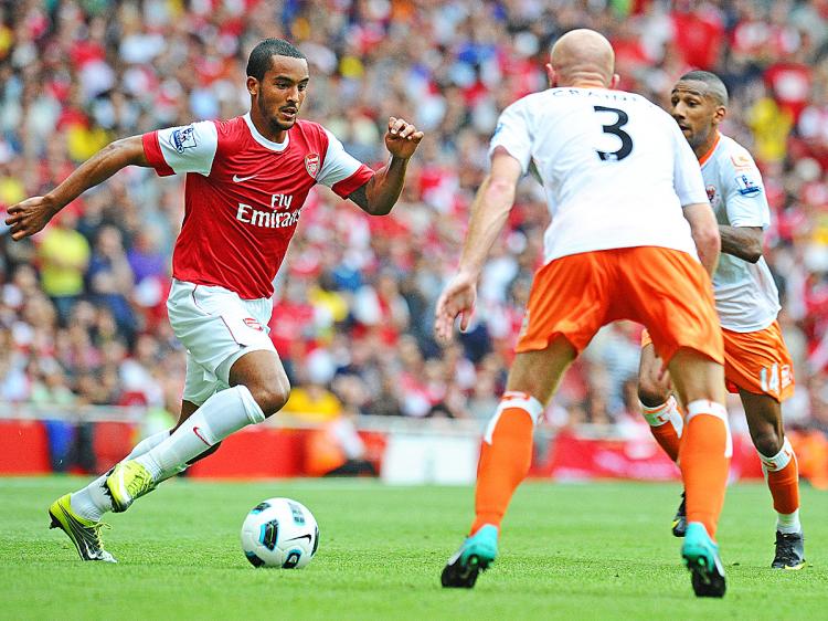 Arsenal's English striker Theo Walcott (L), scorer of three of Arsenal's six goals in action during the English Premier League football match between Arsenal and Blackpool at the Emirates Stadium in London, England. (Carl De Souza/AFP/Getty Images)