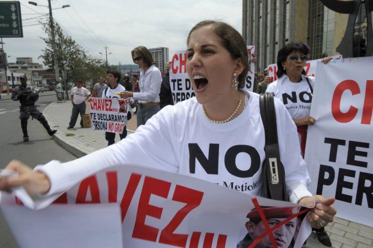 A woman holds a poster reading 'Chavez, we declare you persona non grata', during a protest in Quito against Venezuelan President Hugo Chavez. Tensions seem ready to boil giving rise to speculation that Chavez may be plotting a coup to maintain his presidency and head off a spontaneous explosion. (Rodrigo Buendia/AFP/Getty Images)