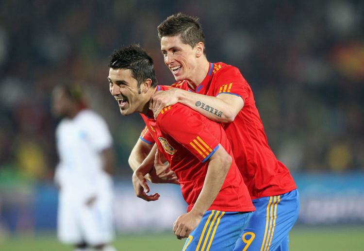 David Villa (left) is congratulated by fellow striker Fernando Torres after giving Spain a two-goal lead against Honduras on Monday. (Christof Koepsel/Getty Images)