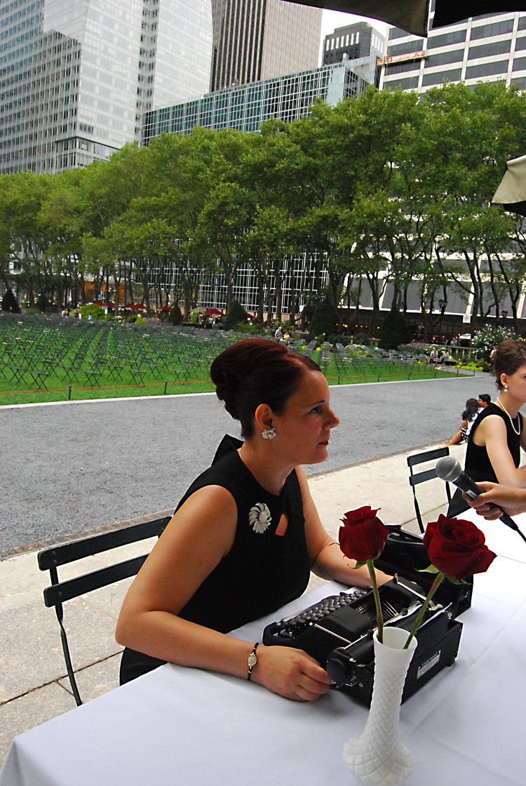 Artist Sheryl Oring sits at a typewriter in Bryant Park on Sunday, Sept. 11, as a part of her public art project 'Collective Memory.' New Yorkers stopped by to answer the question, 'What would you like the world to remember about 9/11?' Friday through Sunday. (Catherine Yang/The Epoch Times)