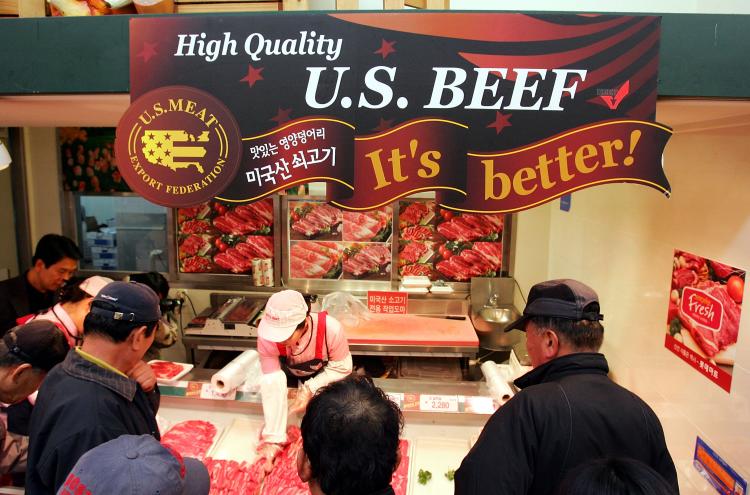 Customers buy imported U.S. beef at a store in Seoul. South Korea banned both U.S. and Canadian beef imports in 2003 amid concerns over BSE, or mad cow disease. The sale of U.S. beef has resumed while Korea continues to ban Canadian beef with the same BSE risk status. (Chung Sung-Jun/Getty Images)