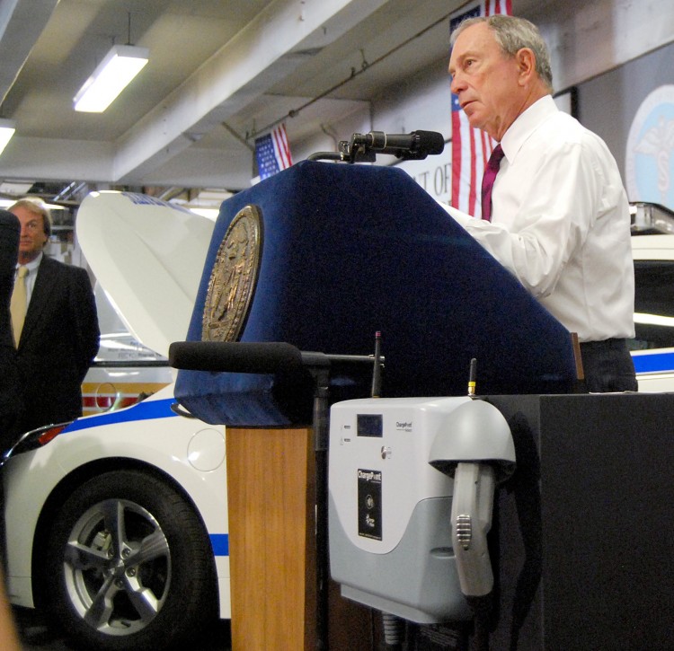 CLEANER ENERGY: Seventy new electric vehicles have been added to the cityÃ�Â¢Ã¯Â¿Â½Ã¯Â¿Â½s municipal fleet. Mayor Bloomberg stands by a model electric charging station in front of a Chevrolet Volt to be used by the NYPD, at the Department of Sanitation Central Repair Shop in Queens on Tuesday. These will be the first electric cars used by the NYPD.  (Catherine Yang/The Epoch Times)