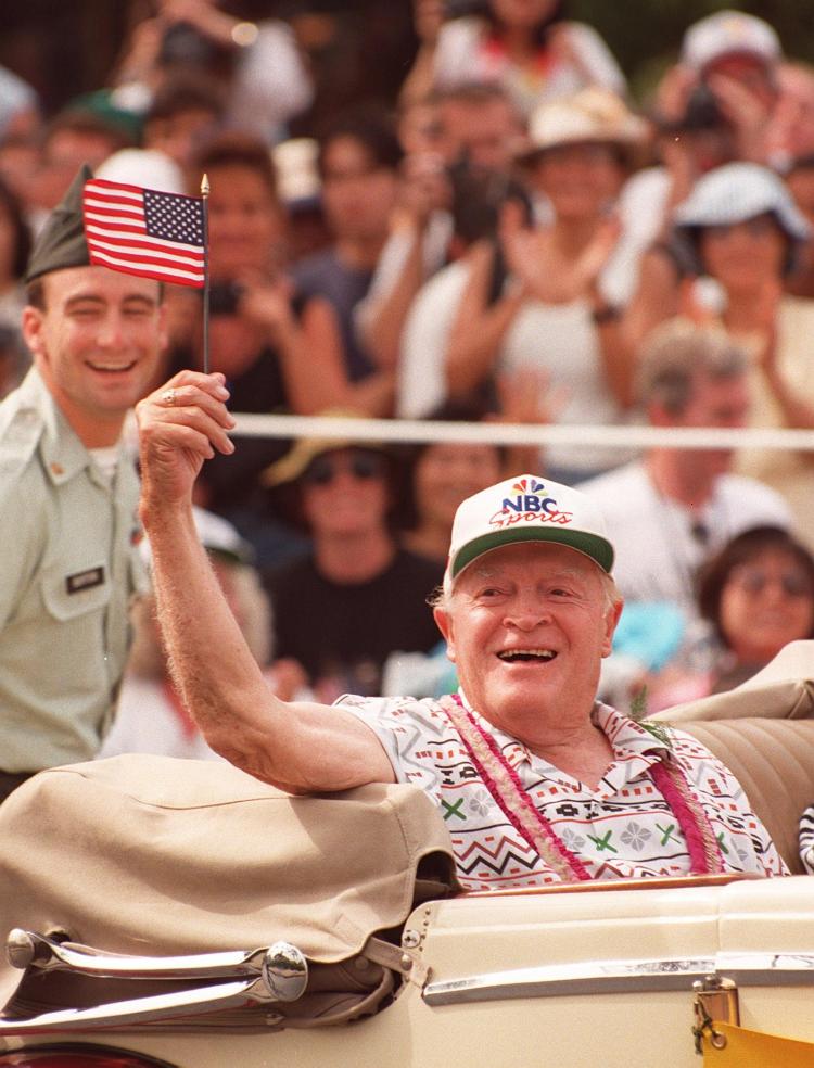 This September 1, 1995 file photo shows US comedian Bob Hope waving from a car during a parade in Honolulu, Hawaii. (Luke Frazza/AFP/Getty Images)