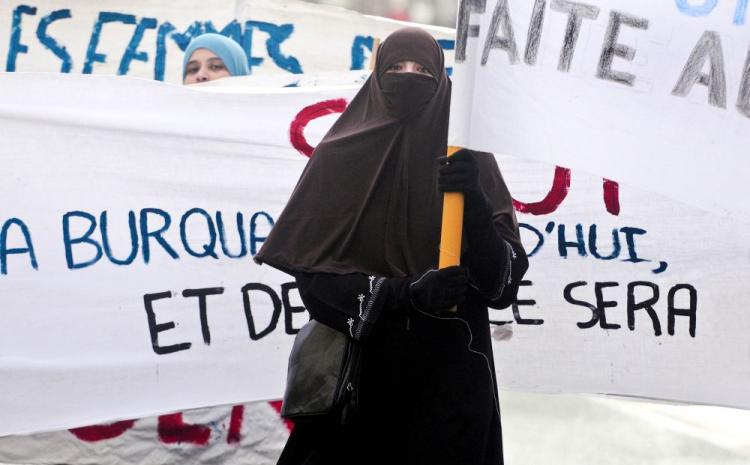 A woman wearing a 'niqab' veil participates in a protest on Feb. 6, 2010 in France, after a panel of French lawmakers recommended a ban on the face-covering veil in all schools, hospitals, public transportation, and government offices.  (Alain Jocard/AFP/Getty Images)