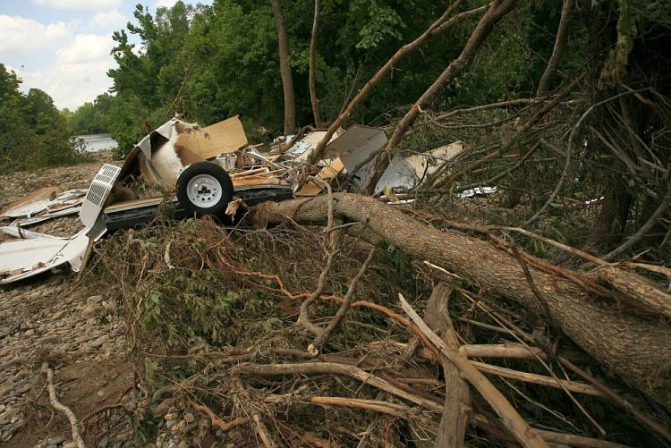 A destroyed camper rests on a pile of downed trees in the aftermath of a flash flood in Arkansas in June.  (David Yerby/Getty Images)