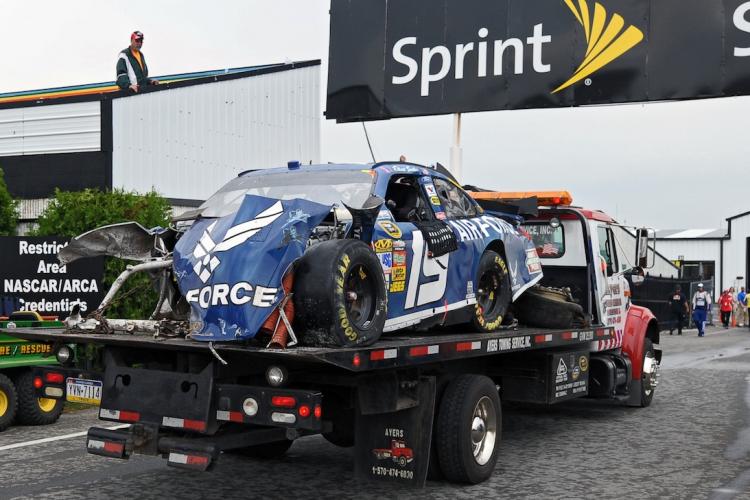 The wrecked No. 19 Air Force Ford, driven by Elliott Sadler, gets towed through the garage area after he hit the wall in the NASCAR.  (Drew Hallowell/Getty Images for NASCAR)