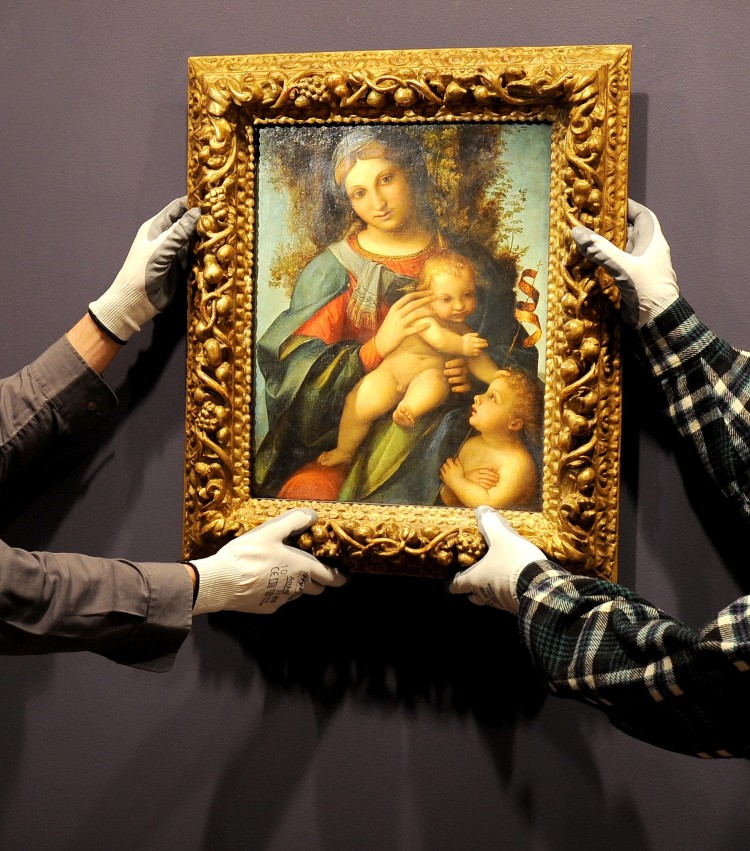 RARE ACQUISITION: The National Gallery of Victoria (NGV) hangs its newly acquired painting 'Madonna and Child With Infant St. John the Baptist,' by Italian Renaissance painter Correggio. The NGV bought it for $5.45 million on Aug. 17 in London. The newly discovered work from the early 16th century is the only authenticated Correggio in the last 50 years to have been sold at auction, according to the NGV. It was purchased using a donation from Australian investment manager Andrew Sisson. 'Mr. Sisson said the strong dollar, relative to sterling, had increased his purchasing power by about 50 percent at the Sotheby's auction,' according to a report by The Australian. (William West/AFP/Getty Images)