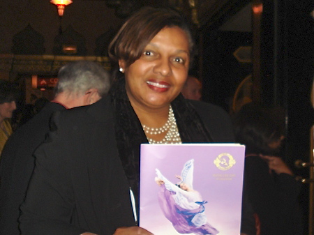 Debra Harrell holds her 2013 Shen Yun