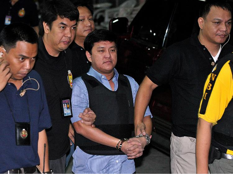 Andal Ampatuan Jr. (C), on the opening day of his court hearing, on Feb. 3 for the massacre of 57 people including 30 journalists. His father, Andal Ampatuan Sr., the patriarch of a powerful clan, was charged on Feb. 9 with ordering the slaughter in the southern Philippines on Nov. 23, 2009. Another 196 others also face charges. (Jay Directo/AFP/Getty Images)